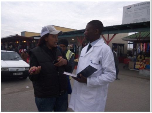 Field agent interviewing a man at a market
